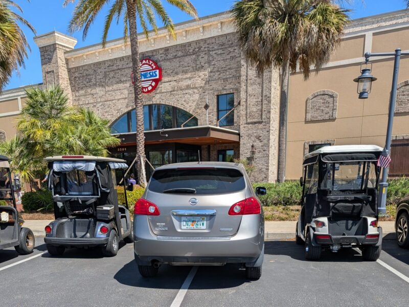This SUV squeezed in between two golf carts at Genesis Health Club at Brownwood