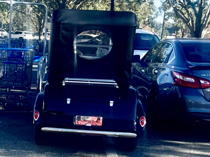 This golf cart squeezed in between a cart corral and another vehicle at Walmart at Buffalo Ridge Plaza
