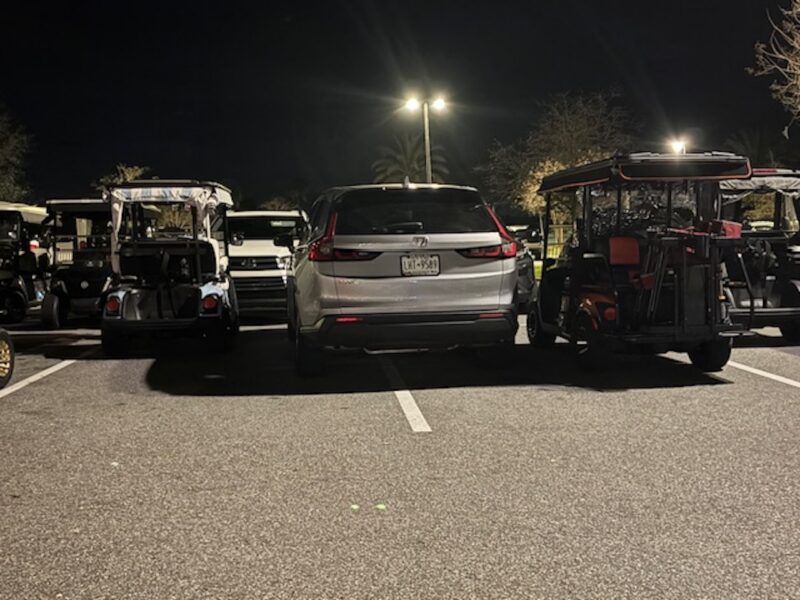 This vehicle from New York was squeezed in between two golf carts at Sawgrass Grove in The Villages
