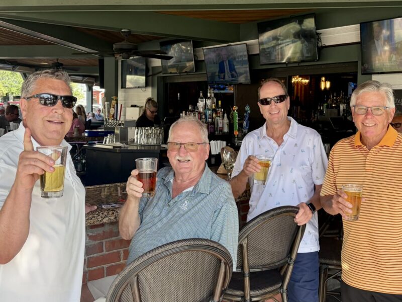 Villager John Graham, third from left, bought the drinks at City Fire after getting his first lucky ace