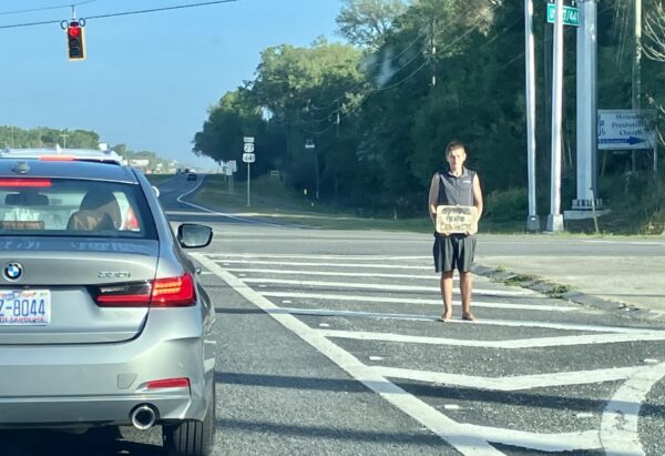 A BMW waits at the light as a man begs for money on U.S. Hwy. 441 in Marion County A BMW waits at the light as a man begs for money on U.S. Hwy. 441 in Marion County