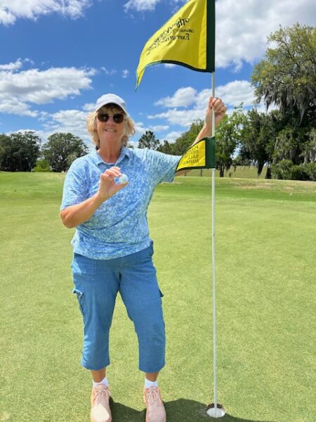 Linda Giebler proudly shows off her ball after scoring the lucky ace Linda Giebler proudly shows off her ball after scoring the lucky ace