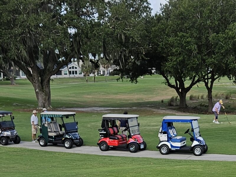 Four golf carts for four golfers were lined up at a course in The Villages