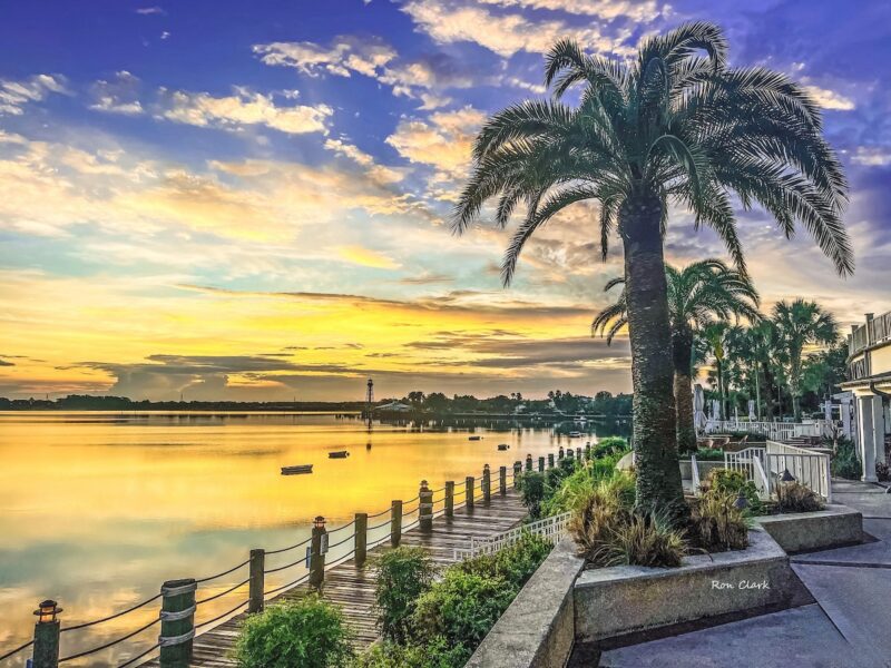 Golden sunrise glows over Lake Sumter Landing boardwalk