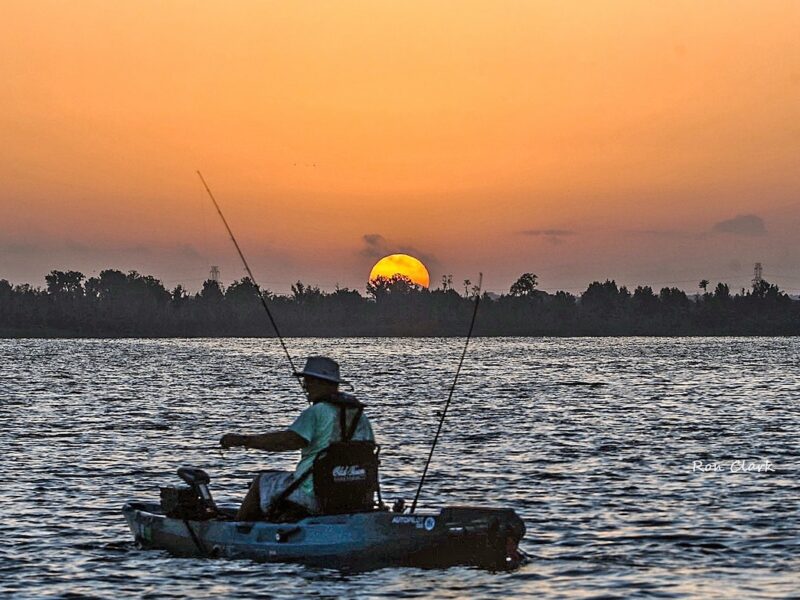 Kayaker enjoys peaceful sunrise at Lake Deaton Park