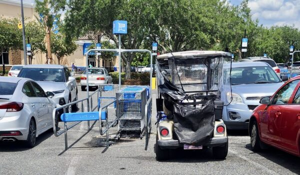 This golf cart driver squeezed in next to the cart corral at Walmart at Buffalo Ridge Plaza in The Villages This golf cart driver squeezed in next to the cart corral at Walmart at Buffalo Ridge Plaza in The Villages