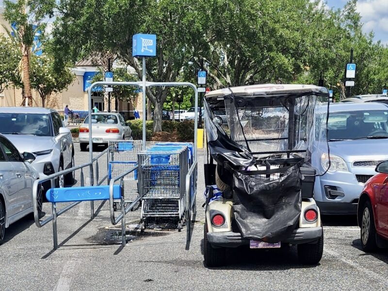 This golf cart driver squeezed in next to the cart corral at Walmart at Buffalo Ridge Plaza in The Villages