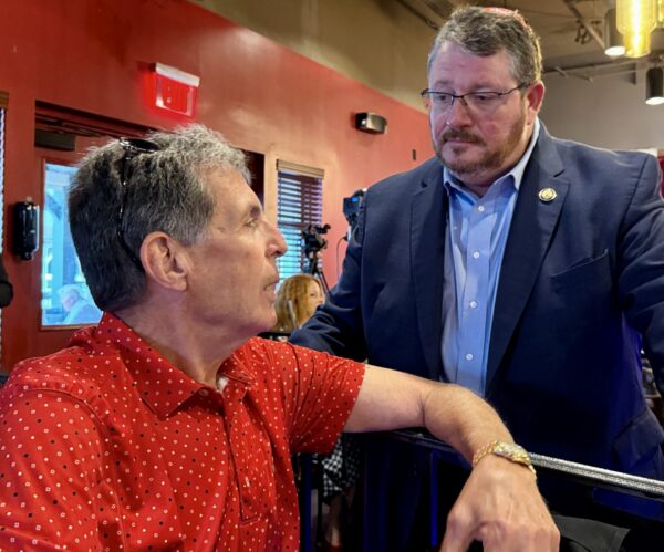 Tom Cannizzaro, left, of the Village of Waters Edge speaks with Congressman Randy Fine at City Fire