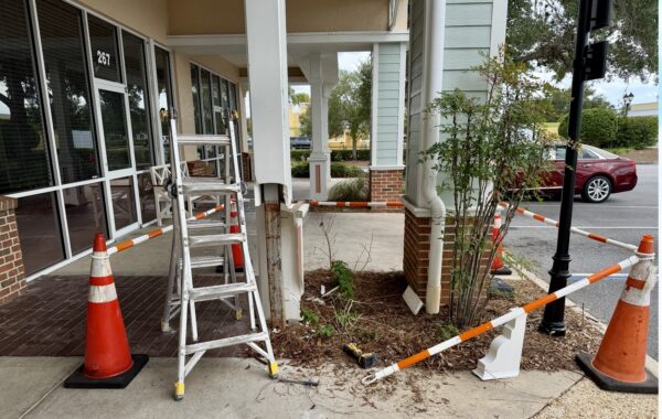 Cones were set up to block off the pilar after it was struck by the woman s car at Colony Plaza