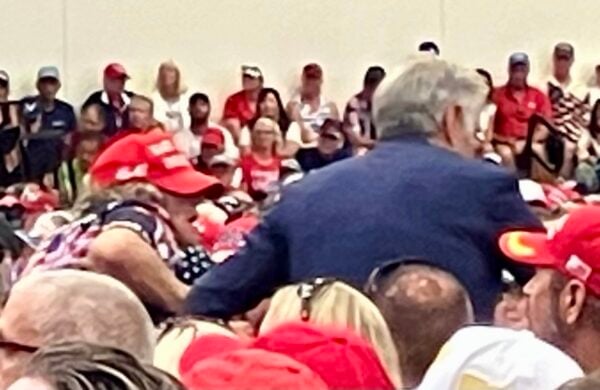 Dr. Oz Mehmet, in blue suit, escoted a woman suffering from a medical episode out of The Villages High School gym during President Trump s speech Dr. Oz Mehmet, in blue suit, escoted a woman suffering from a medical episode out of The Villages High School gym during President Trump s speech