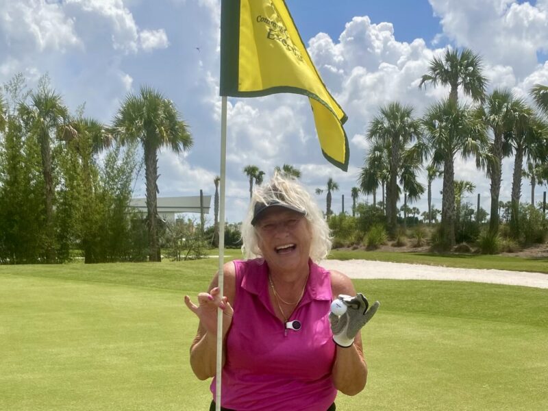 Jeanne Wanner of the Village of Citrus Grove shows off her golf ball after scoring the lucky ace