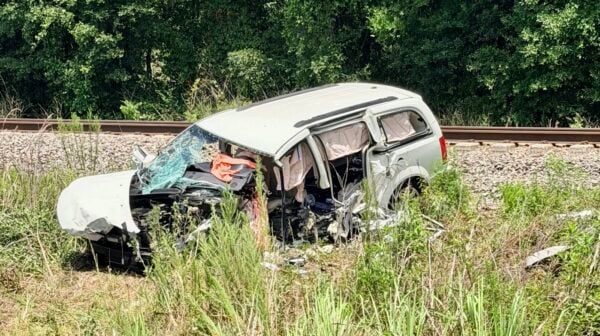 The driver of this white Chrysler minivan died as a result of the crash