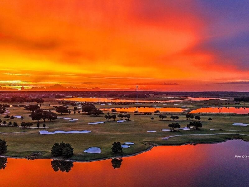 Vibrant sunrise casts an orange glow over Belle Glade Country Club