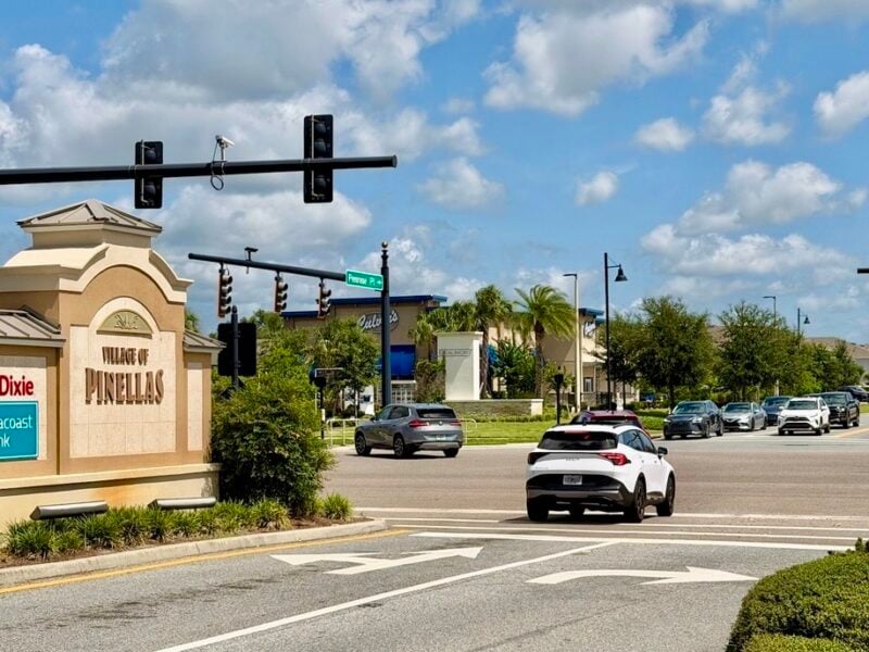 Villager fighting for golf cart crossing to access retail and restaurants