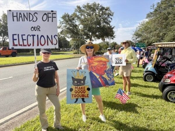 Helen Shapiro of Virginia Trace and Terry Baker of Edenfield held signs at the rally. Helen Shapiro of Virginia Trace and Terry Baker of Edenfield held signs at the rally.