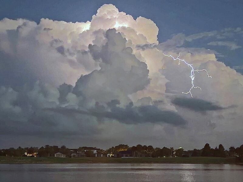 Nighttime storm clouds light up over Lake Sumter Landing