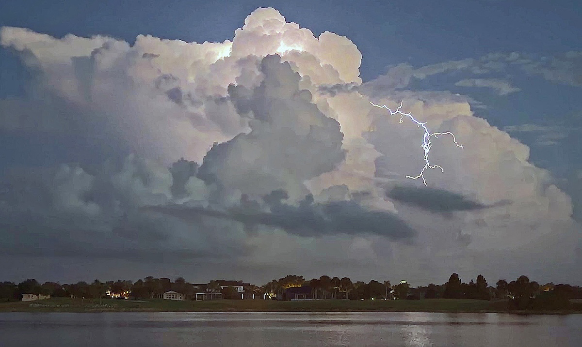 Nighttime storm clouds light up over Lake Sumter Landing Nighttime storm clouds light up over Lake Sumter Landing