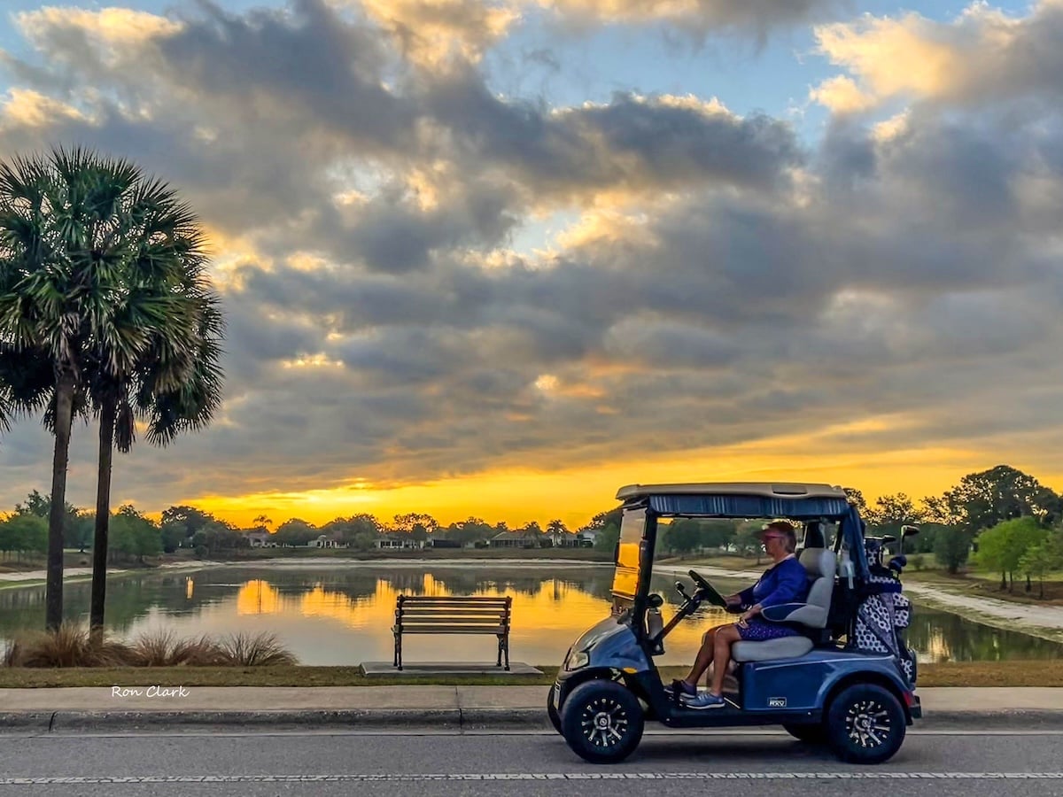 Sunrise golf cart drive captured by Ashland Pond in The Villages